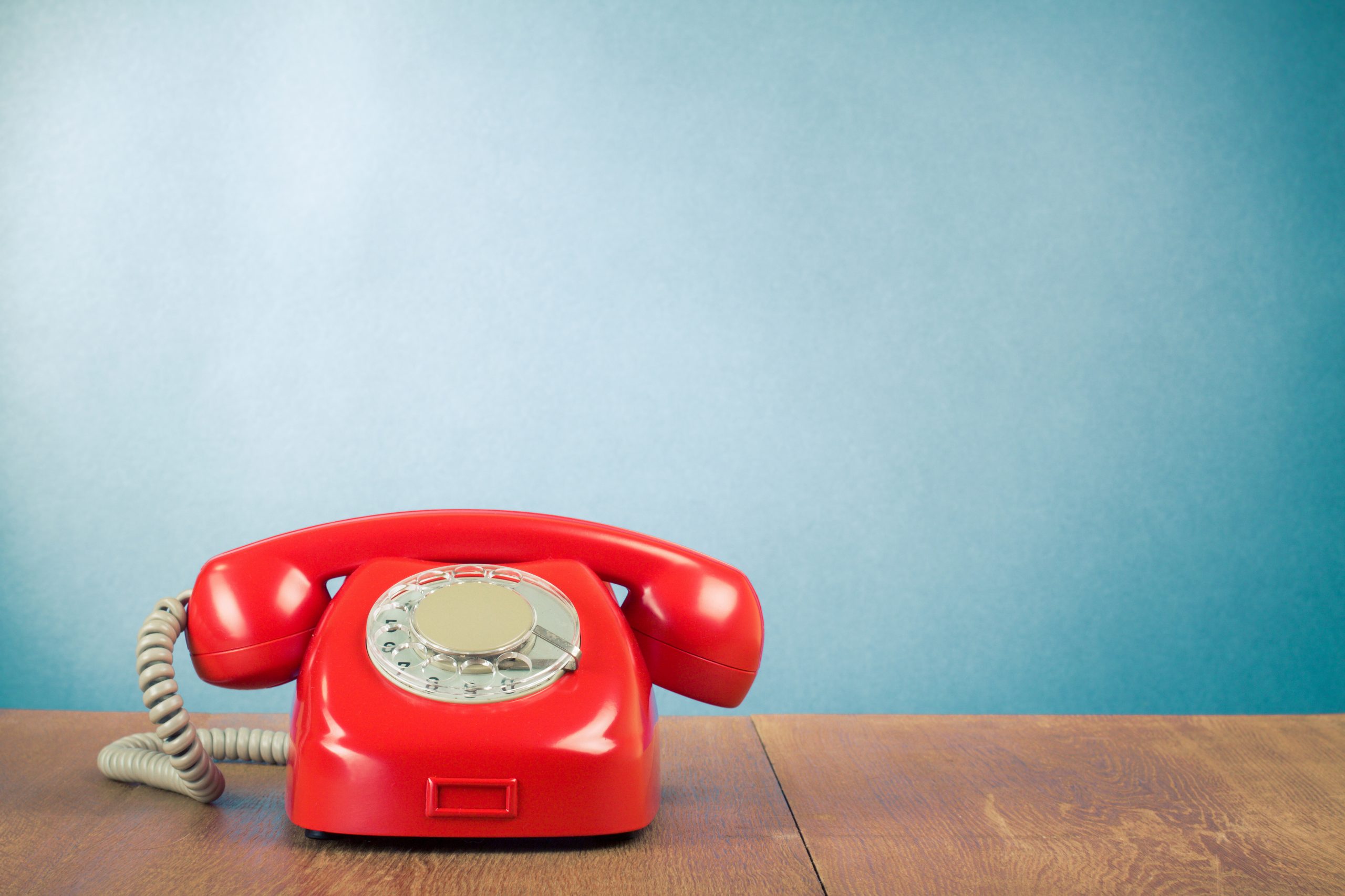 Retro,Red,Telephone,On,Wood,Table,Near,Aquamarine,Wall,Background